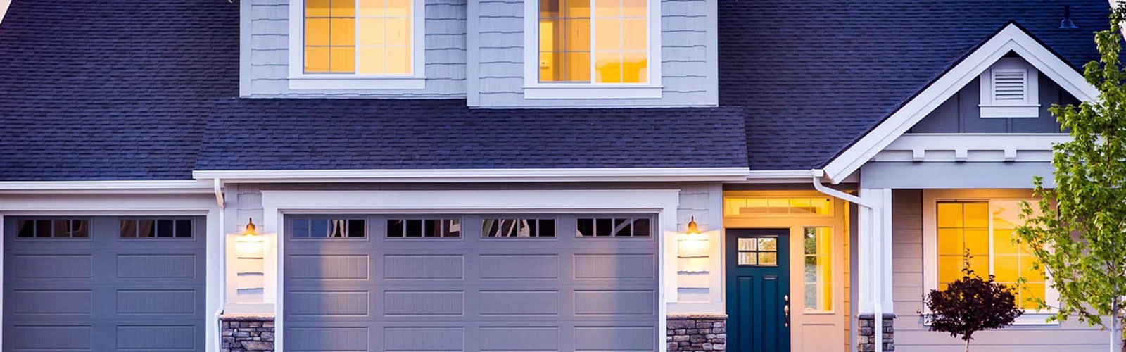 Two-story home in the Upstate at dusk with the lights on